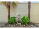 Charming backyard fountain with decorative shrubbery and tall palm trees at 620 Stickley Oak Way, Woodstock, GA 30189
