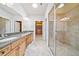Well-lit bathroom with double vanity, a glass-enclosed shower, and tile flooring at 620 Stickley Oak Way, Woodstock, GA 30189