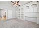 Bright bedroom with built-in shelving, a ceiling fan, and an ensuite bathroom at 620 Stickley Oak Way, Woodstock, GA 30189