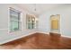 Dining room with hardwood floors, chandelier, and arched doorway at 620 Stickley Oak Way, Woodstock, GA 30189