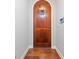 Entryway featuring an arched wood front door and hardwood floors at 620 Stickley Oak Way, Woodstock, GA 30189