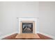 Close up of a white fireplace with marble surround and hardwood floors at 620 Stickley Oak Way, Woodstock, GA 30189