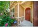 Close up of the front entrance with a custom wooden door and security system at 620 Stickley Oak Way, Woodstock, GA 30189