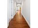 Hallway featuring hardwood floors, white trim, and arched doorway at 620 Stickley Oak Way, Woodstock, GA 30189