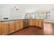 Open kitchen showcases granite countertops, stainless steel appliances, and light wood cabinetry at 620 Stickley Oak Way, Woodstock, GA 30189