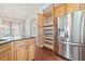 Kitchen features stainless steel refrigerator, granite counters, light cabinets and ample storage space at 620 Stickley Oak Way, Woodstock, GA 30189