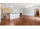 Spacious living room featuring hardwood floors, a fireplace, and an open kitchen concept at 620 Stickley Oak Way, Woodstock, GA 30189
