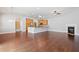 Open-concept living area with fireplace, kitchen bar and hardwood floors at 620 Stickley Oak Way, Woodstock, GA 30189