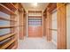 Spacious walk-in closet with custom wooden shelving and drawers for maximum storage and organization at 620 Stickley Oak Way, Woodstock, GA 30189