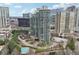 Aerial view of a high rise building in the city with beautiful landscaping and pool at 700 Park Regency Ne Pl # 1203, Atlanta, GA 30326