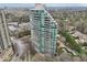 Stunning aerial view of a modern high-rise condo building with a curved facade and lush landscaping at 700 Park Regency Ne Pl # 1203, Atlanta, GA 30326