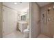 Bright bathroom featuring a walk-in shower with tiled walls, a vanity, and a toilet at 700 Park Regency Ne Pl # 1203, Atlanta, GA 30326