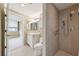 Bright bathroom featuring a walk-in shower with tiled walls, a vanity, and a toilet at 700 Park Regency Ne Pl # 1203, Atlanta, GA 30326