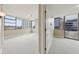Bright bedroom with carpet, many windows, and access to a balcony with city views at 700 Park Regency Ne Pl # 1203, Atlanta, GA 30326