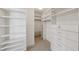 Walk-in closet features extensive custom shelving, drawers, and ample storage space at 700 Park Regency Ne Pl # 1203, Atlanta, GA 30326