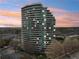 Exterior of luxury high rise condominium building featuring curved design and balconies at 700 Park Regency Ne Pl # 1203, Atlanta, GA 30326
