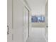 Hallway with closet leads to a large room with neutral carpet and city views at 700 Park Regency Ne Pl # 1203, Atlanta, GA 30326