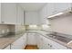 A kitchen featuring granite countertops, an electric range, and all-white cabinetry at 700 Park Regency Ne Pl # 1203, Atlanta, GA 30326