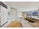 Updated kitchen boasting granite counters, white cabinets and access to living space and outdoor balcony at 700 Park Regency Ne Pl # 1203, Atlanta, GA 30326
