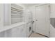 Functional laundry room with stacked washer and dryer, built-in shelving, and ample storage space at 700 Park Regency Ne Pl # 1203, Atlanta, GA 30326