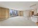 Bright living area with a wall of windows showcasing city views and access to a private balcony at 700 Park Regency Ne Pl # 1203, Atlanta, GA 30326