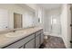 Bathroom with double sink vanity, glass-enclosed shower, toilet, and tile floors at 8594 Secretariat Dr, Lithonia, GA 30058
