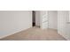 Bedroom with neutral carpet, white trim, closet and door, ready for personal touches at 8594 Secretariat Dr, Lithonia, GA 30058
