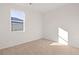 Bright, carpeted bedroom featuring a large window providing ample natural light at 8594 Secretariat Dr, Lithonia, GA 30058