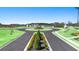 Scenic view of Champion's Run featuring a well-manicured roundabout and lush landscaping at 8594 Secretariat Dr, Lithonia, GA 30058
