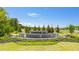Scenic Champions Run community entrance with lush greenery, stone signage, and water fountain at 8594 Secretariat Dr, Lithonia, GA 30058