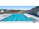 Community pool with lounge seating, a splash pad, and neighborhood homes in the background at 8594 Secretariat Dr, Lithonia, GA 30058