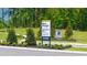 Community sign for Champions Run new homes swim community with contact information at 8594 Secretariat Dr, Lithonia, GA 30058