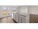 Bright kitchen features a gray island with granite countertops, hardwood floors, and a double glass door at 8594 Secretariat Dr, Lithonia, GA 30058