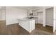 Open-concept kitchen with granite countertops, island seating, and stainless steel appliances at 8594 Secretariat Dr, Lithonia, GA 30058
