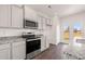 Charming kitchen features stainless steel appliances, granite countertops and a view to the backyard at 8594 Secretariat Dr, Lithonia, GA 30058