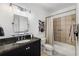Bathroom with granite vanity, decorative mirror, and shower with tiled surround at 3286 Northside Nw Pkwy # 903, Atlanta, GA 30327