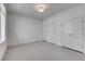 Spacious carpeted bedroom featuring three closets and neutral decor for a cozy feel at 3286 Northside Nw Pkwy # 903, Atlanta, GA 30327