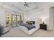 Sun-filled bedroom with a ceiling fan, balcony access, and plush white bedding at 3286 Northside Nw Pkwy # 903, Atlanta, GA 30327