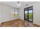 Bedroom with wood floors, ceiling fan, and balcony access with treetop views at 3286 Northside Nw Pkwy # 903, Atlanta, GA 30327