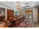 Elegant dining room featuring a large table, ornate chandelier, and access to an outdoor patio at 3286 Northside Nw Pkwy # 903, Atlanta, GA 30327