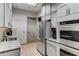 Functional kitchen area features stainless steel appliances and white cabinetry at 3286 Northside Nw Pkwy # 903, Atlanta, GA 30327
