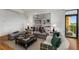 Comfortable living room featuring hardwood floors, cozy seating, and a walkout to a balcony at 3286 Northside Nw Pkwy # 903, Atlanta, GA 30327