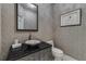 Stylish powder room with a vessel sink, granite countertop, and patterned wallpaper at 3286 Northside Nw Pkwy # 903, Atlanta, GA 30327