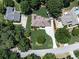 Stunning aerial view of a home with verdant landscaping, mature trees, and a long driveway at 427 Picketts Lake Dr, Acworth, GA 30101