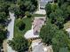 Aerial view of a lovely home with well-manicured landscaping and a curved driveway, nestled among mature trees at 427 Picketts Lake Dr, Acworth, GA 30101
