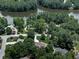 An elevated view of a home with mature trees, lush greenery, and access to a lake at 427 Picketts Lake Dr, Acworth, GA 30101