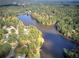 An aerial of the community with an open view of the lake and surrounded by lush greenery and mature trees at 427 Picketts Lake Dr, Acworth, GA 30101