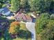 Aerial shot of a charming home with mature trees, a long driveway, and lush green lawns at 427 Picketts Lake Dr, Acworth, GA 30101