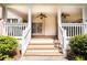 Covered back porch with wooden steps leading to a well-maintained yard at 427 Picketts Lake Dr, Acworth, GA 30101