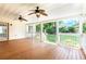 Covered back porch with ceiling fans and view of a well-manicured backyard at 427 Picketts Lake Dr, Acworth, GA 30101